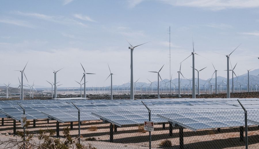 Wind turbines and a solar farm generating renewable power