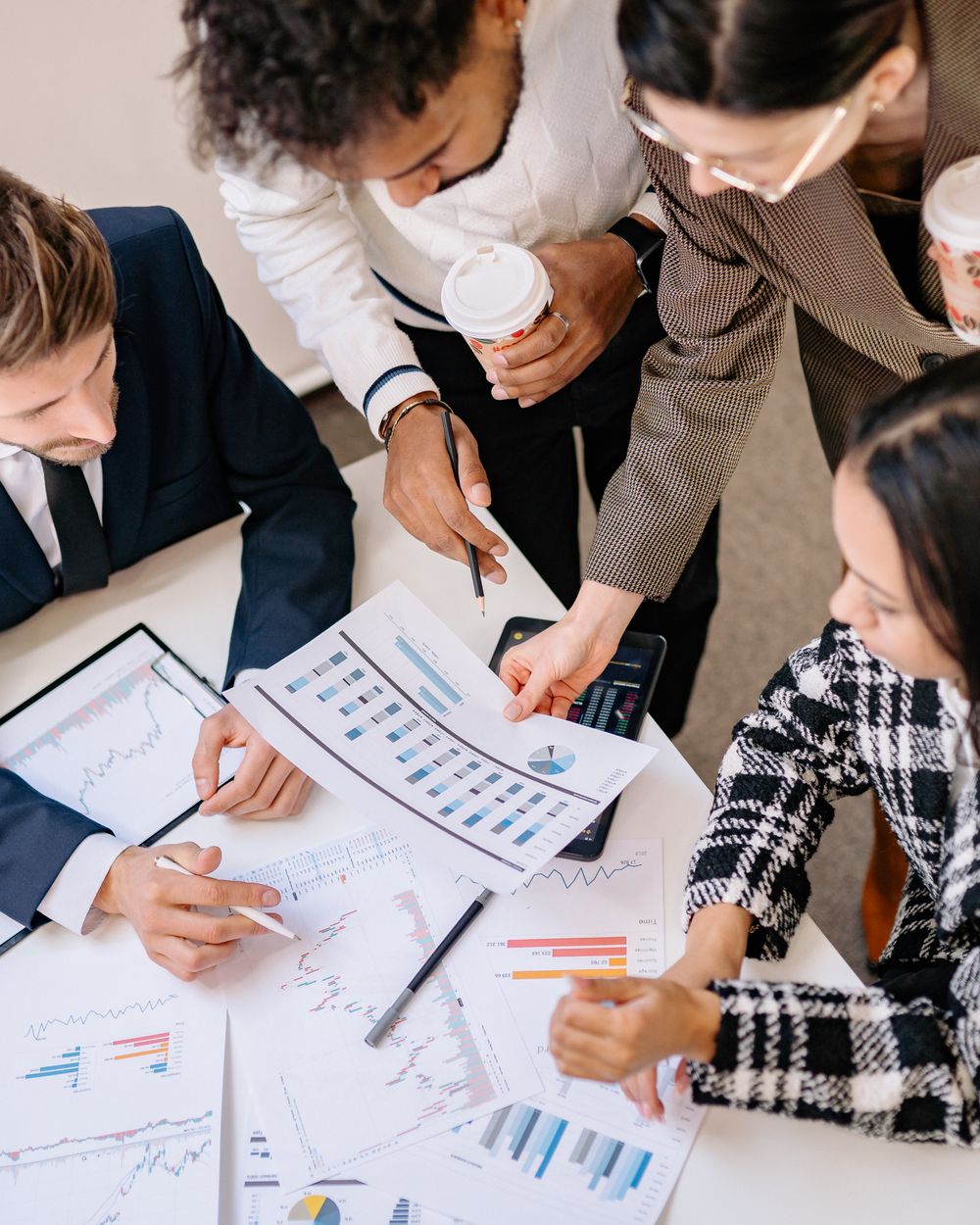 A team collaborating over commercial analysis and charts