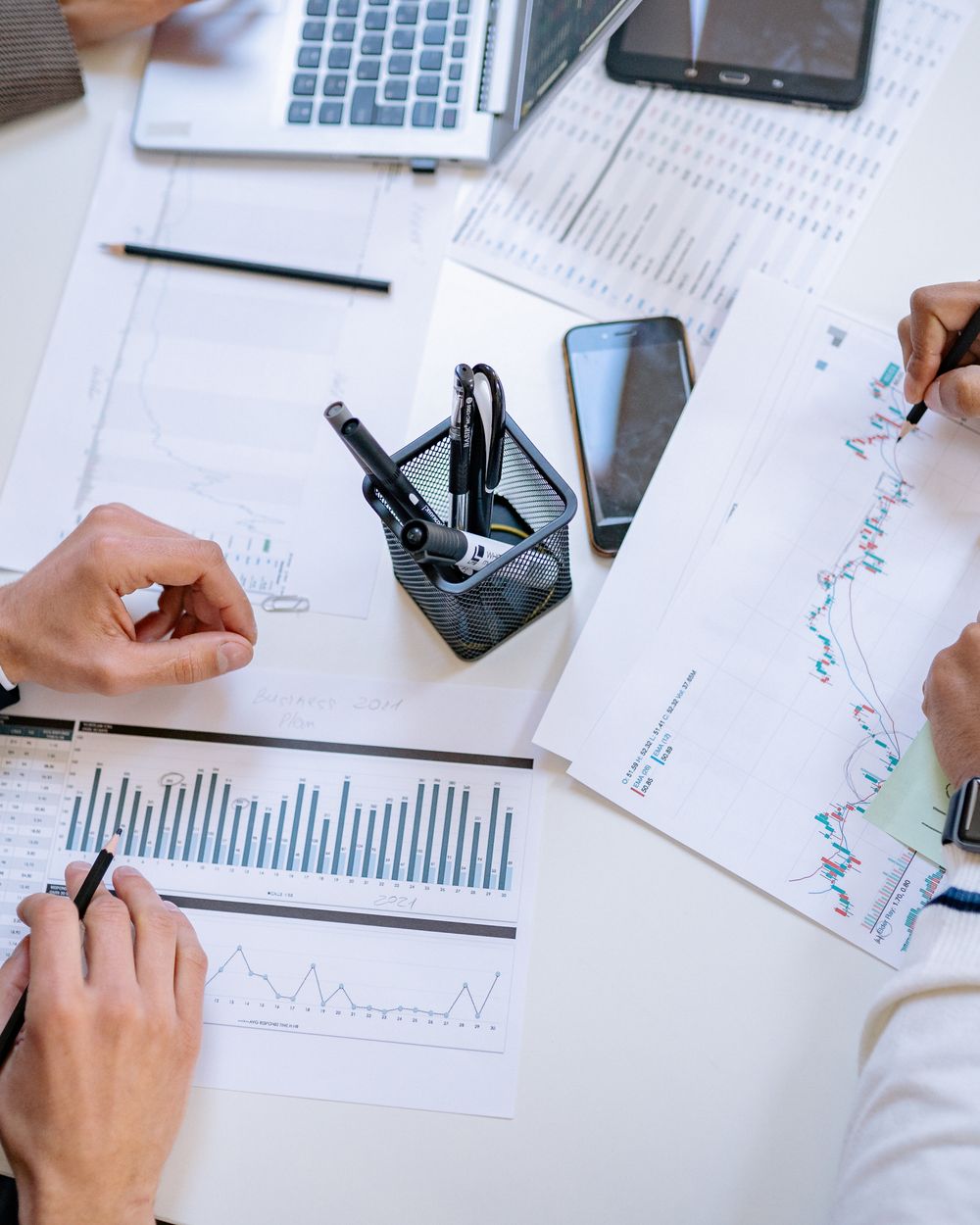 Analysts reviewing market data across sectors